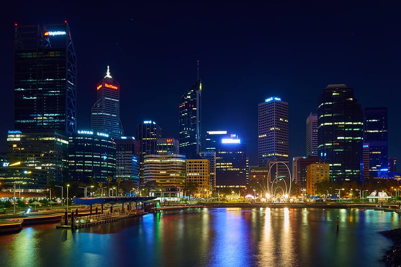 City skyline at night with a river, showcasing the luxurious beauty of Perth's finest hotels.